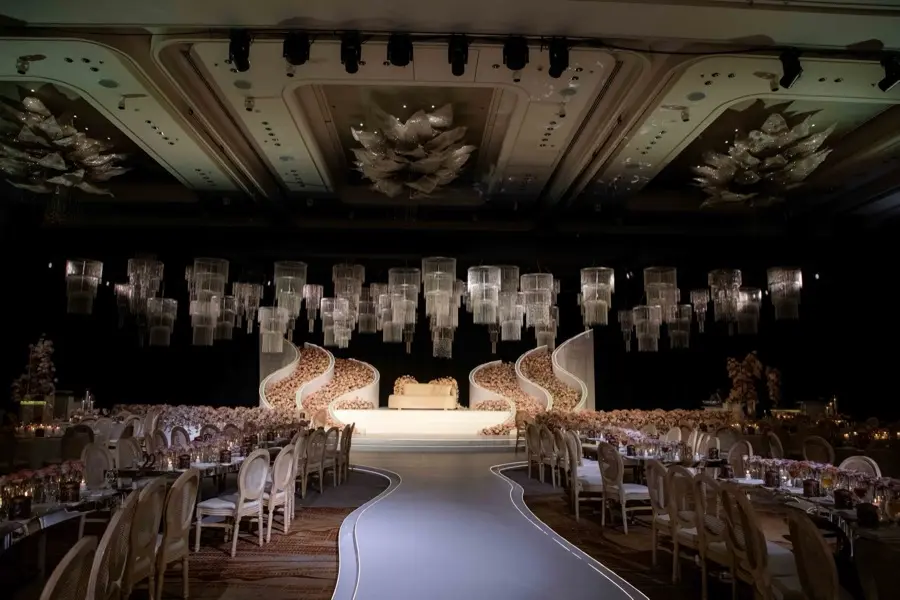 Grand ballroom with cascading crystal chandeliers above a floral stage