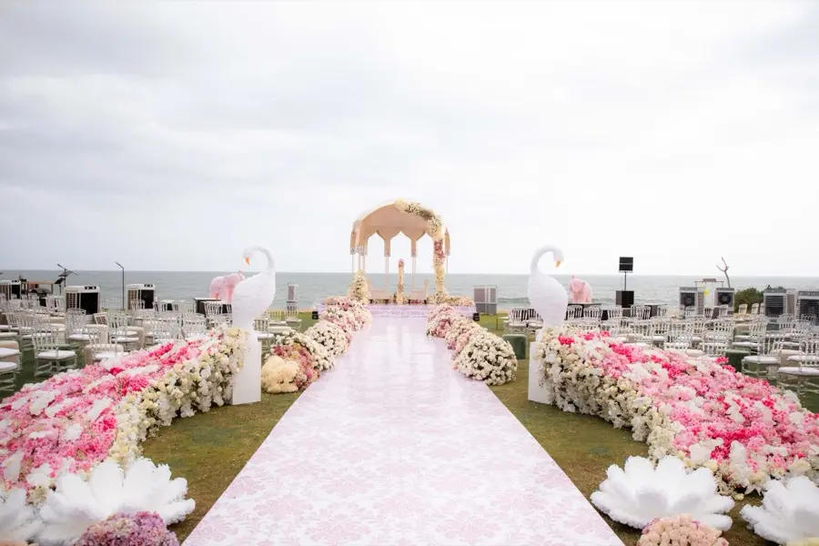 Aisle banked with layered pink and ivory florals