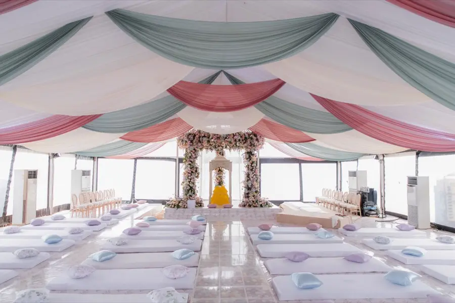 Draped ceremony pavilion staged and empty before guests arrive